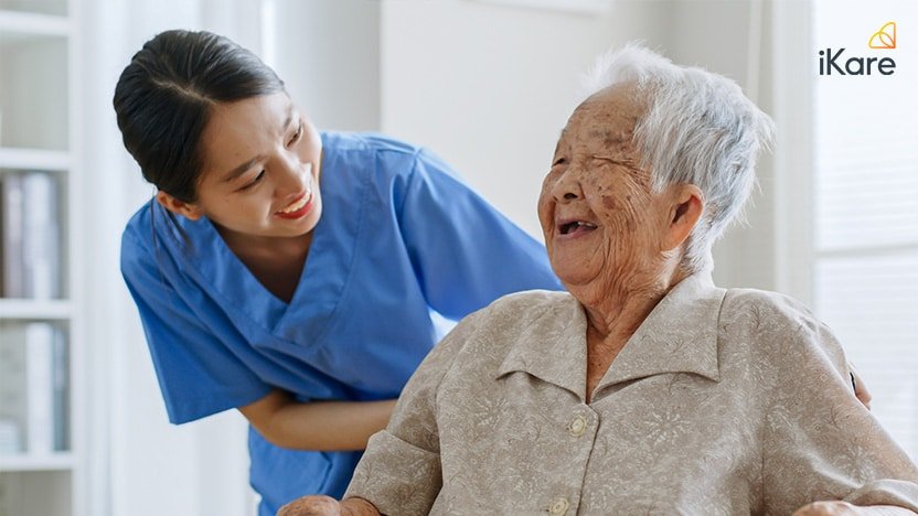 Carer of nursing home talking with senior feeling happy at home