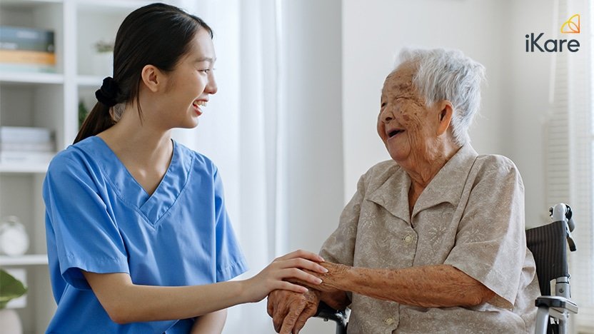 Caregiver Talking With Senior Asian Woman
