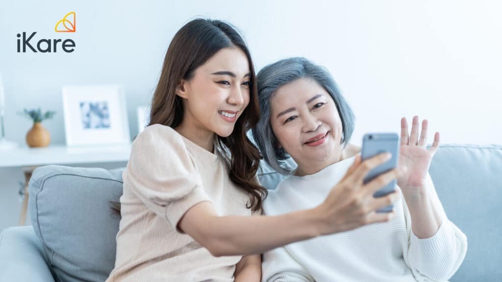 Senior and Daughter Using Handphone to Connect with Loved Ones Virtually