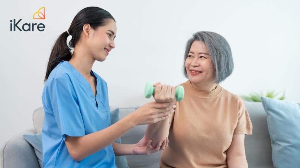 Senior doing physical exercise with Homecare Nurse at home