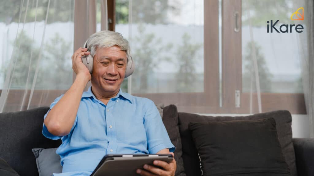 Senior listening to music during music therapy session at home