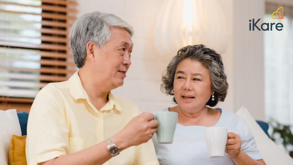 Seniors Holding Glass of Water While Chatting