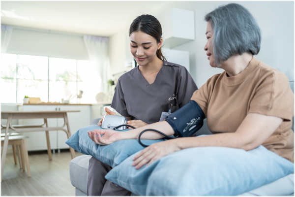 Nurse taking blood pressure reading for home care patient
